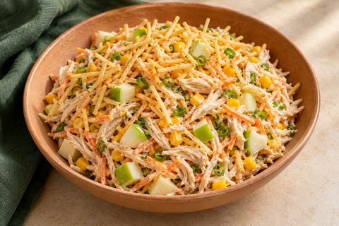 Creamy shredded chicken salad with carrot, corn, green apple, scallions and golden potato sticks